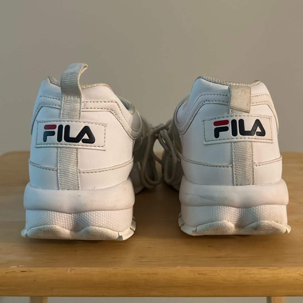 Women’s white sneakers gently warm.